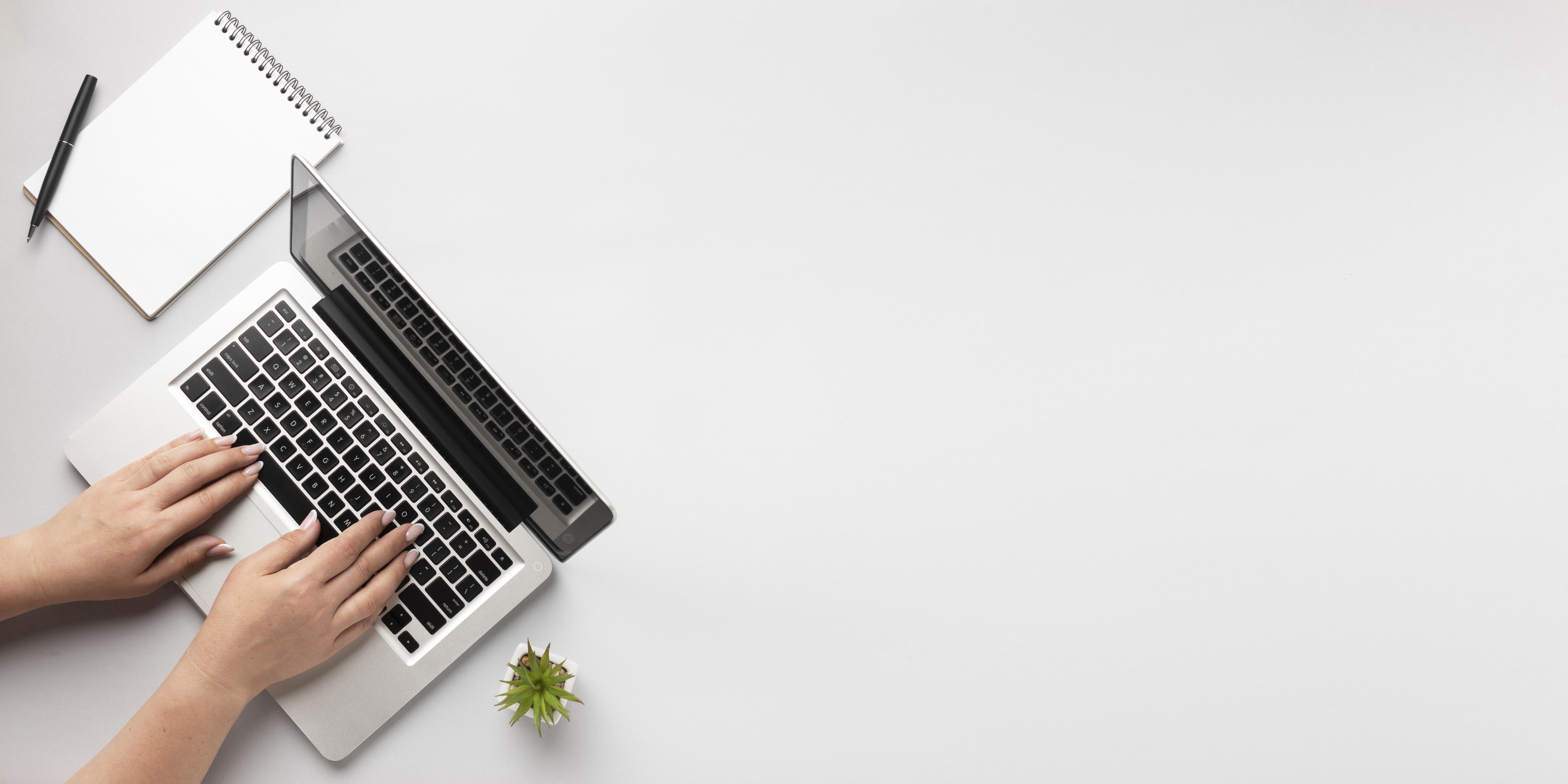 top-view-person-writing-on-laptop-with-copy-space